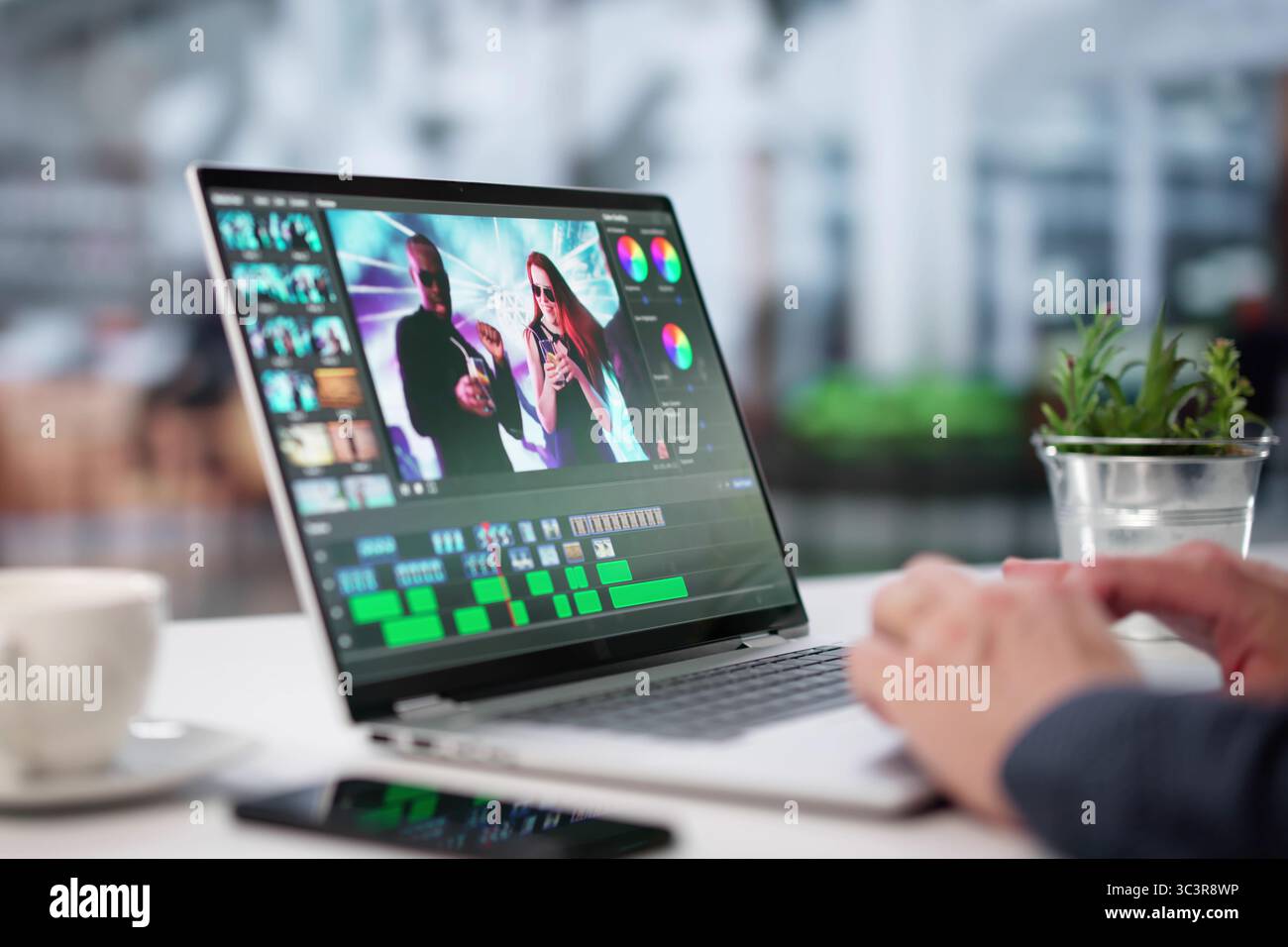 Young Graphic Designer Edits Video Using Advanced Editing Software On Laptop. Stock Photo