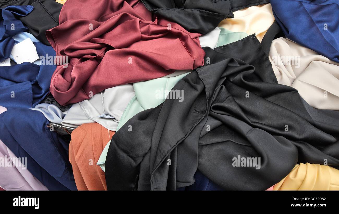 Brightly colored fabrics displayed at a market stall Stock Photo