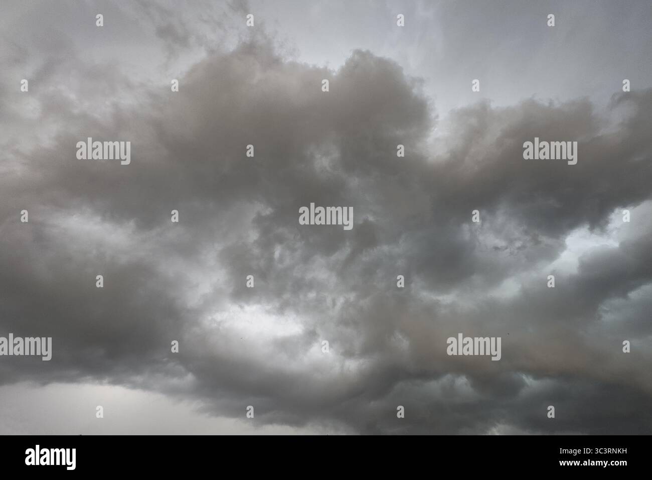 Dark discoloured storm clouds Cloud roll above grey clouds Rain clouds herald thunderstorms, Germany Stock Photo