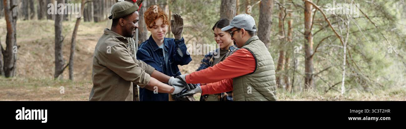 Diverse Young Adults Collaborating Outdoors during Team Building Activity Stock Photo