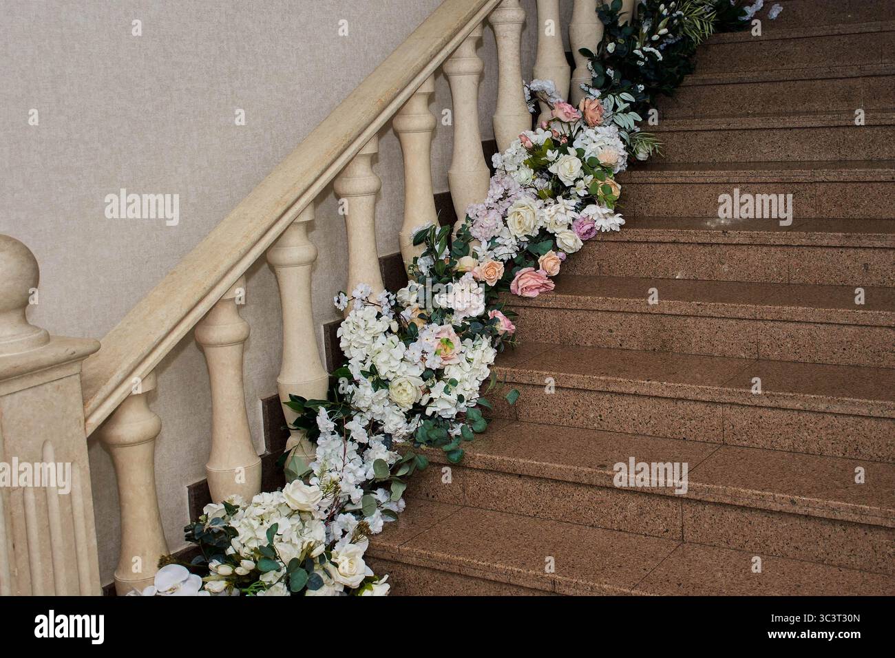 A staircase with bright colorful flowers at a banquet and a wedding ...