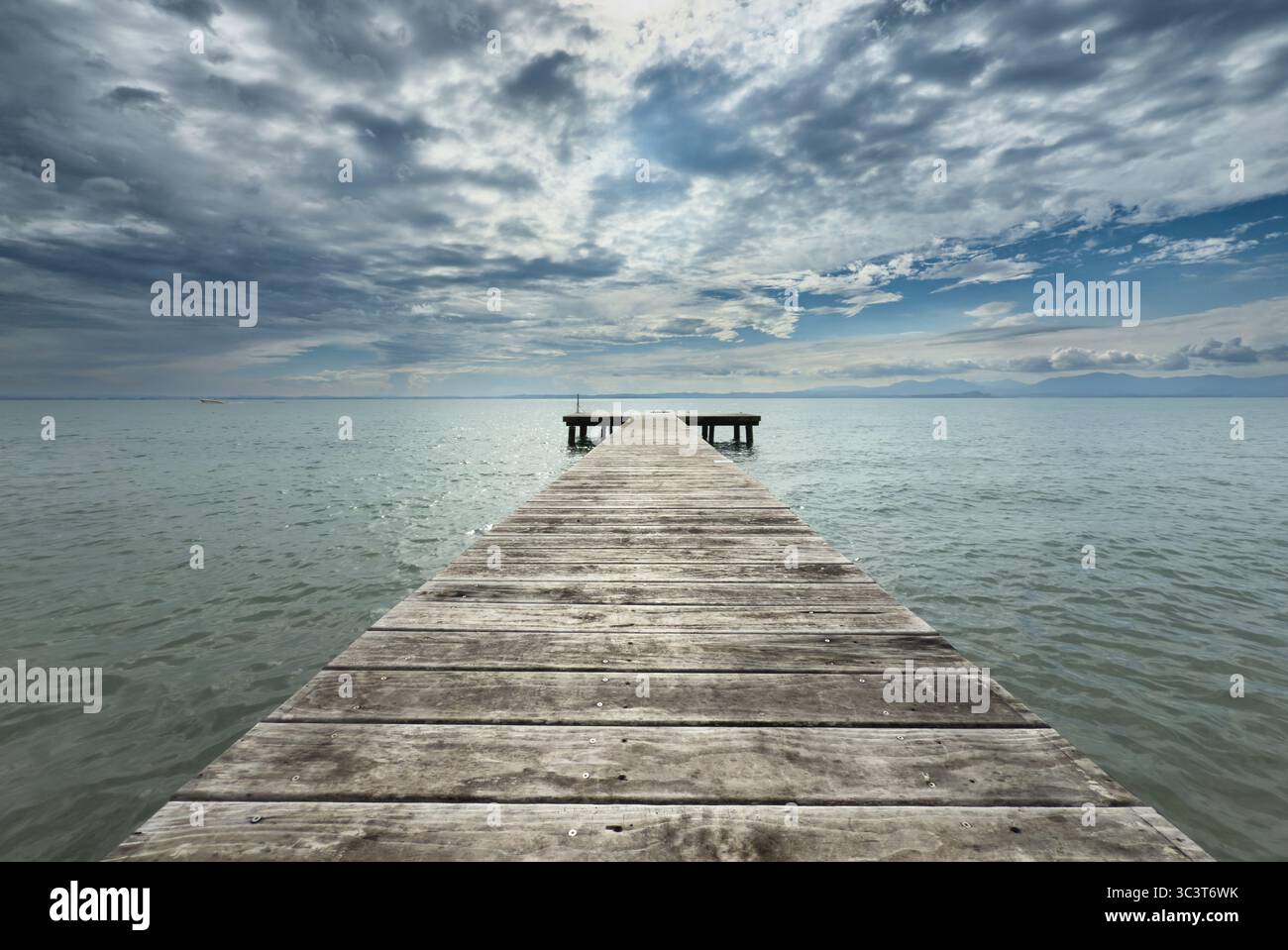 Jetty with dramatic sky at Lazise on Lake Garda, Italy - Smartphone Captured Stock Image