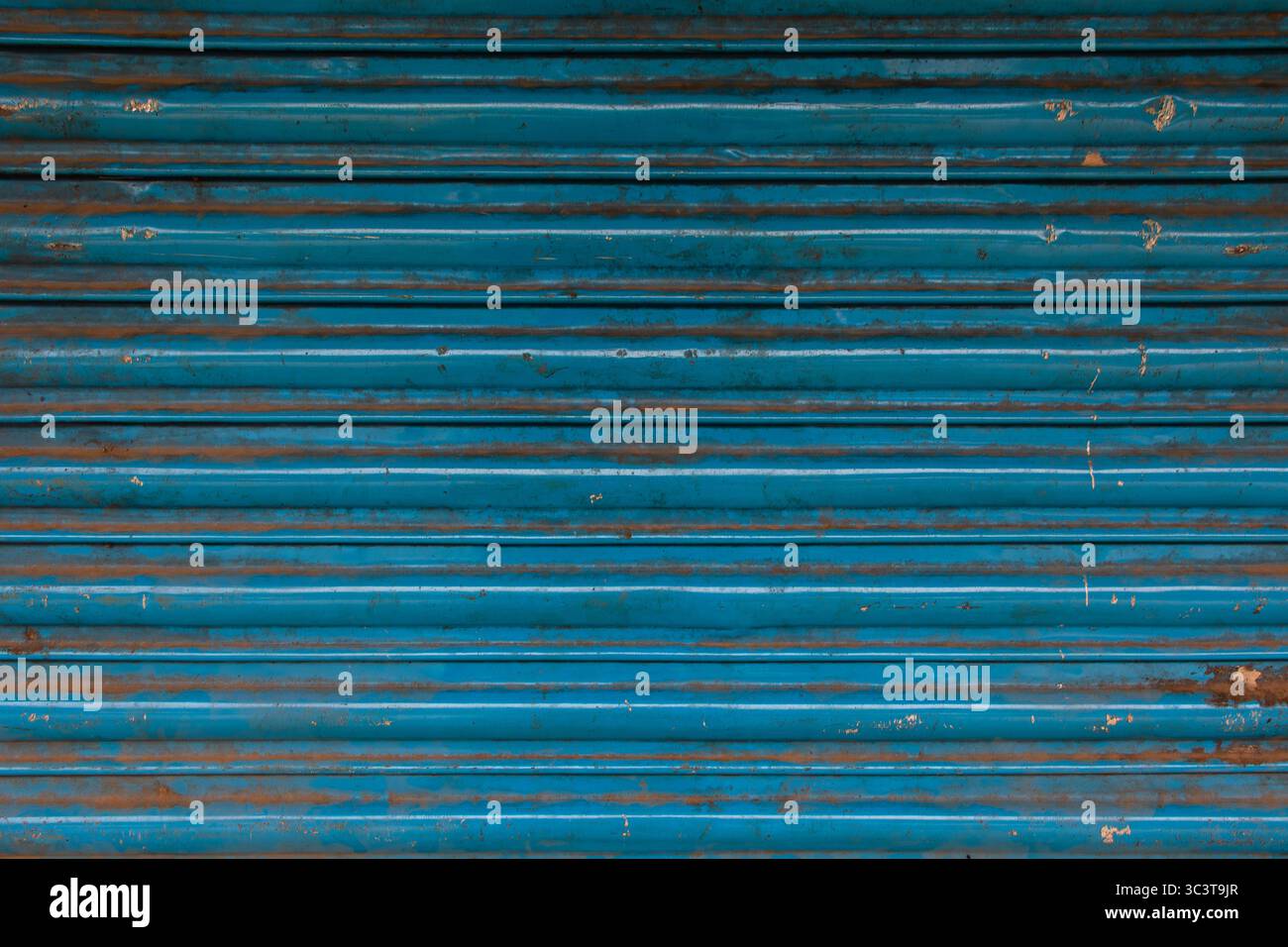 Blue corrugated metal rolling shutter door texture. Stock Photo