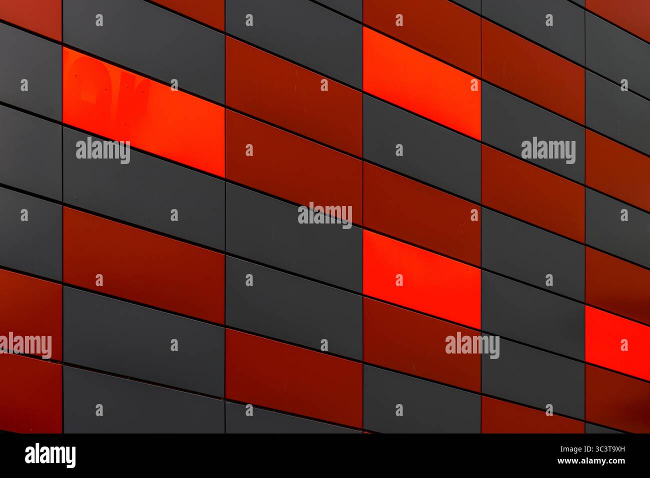 Office building facade with geometric red and black metal cladding ...