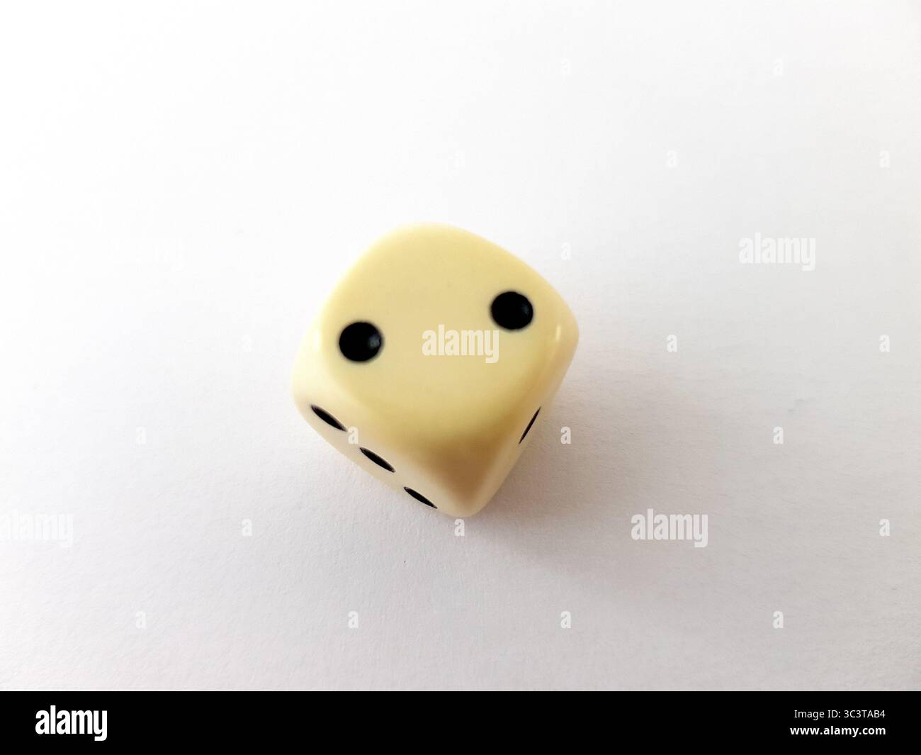 A vintage dice isolated on a white background. Stock Photo