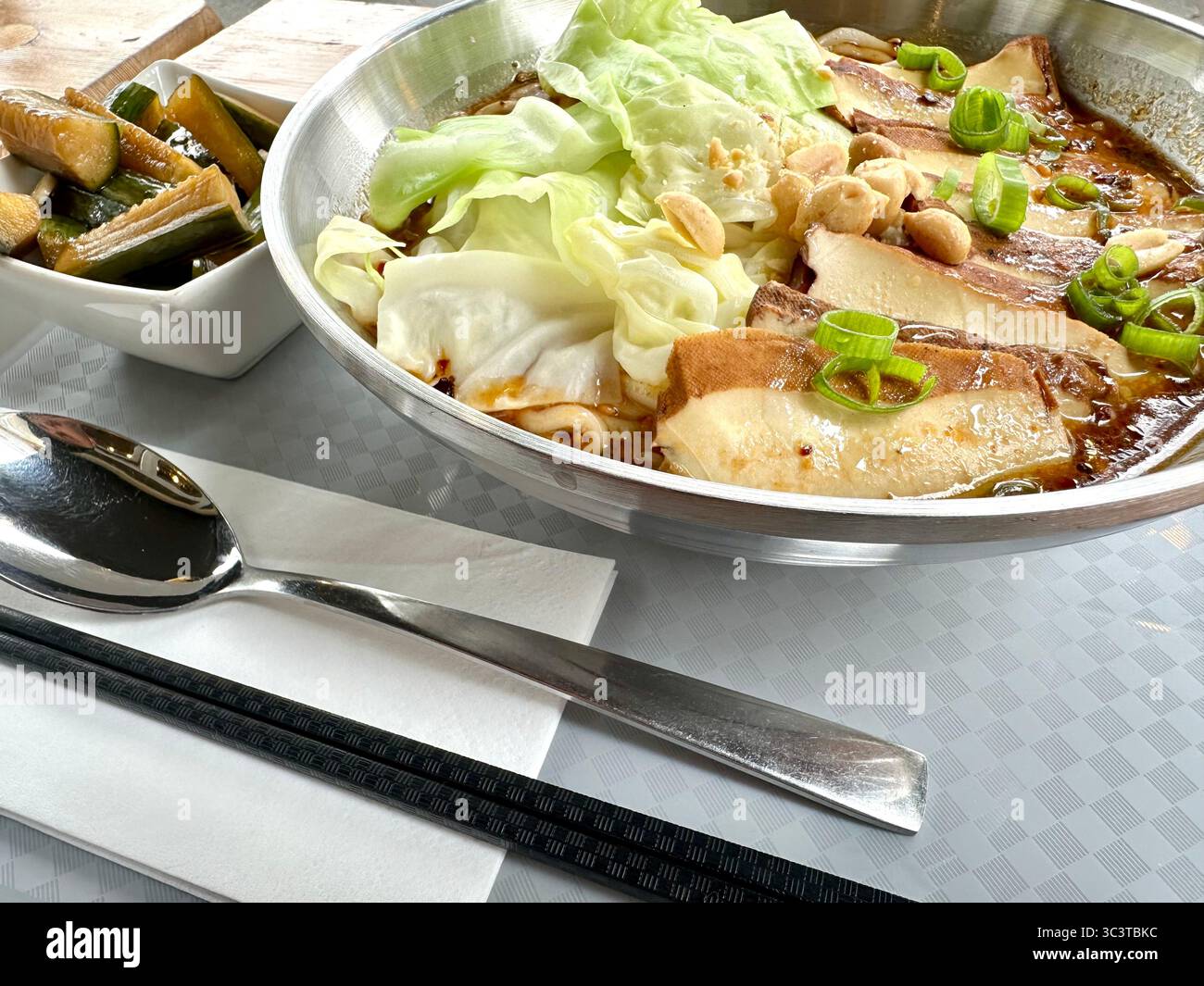 Chongqing noodles with smoked tofu and cucumber salad at a restaurant in Berlin - Smartphone Captured Stock Image