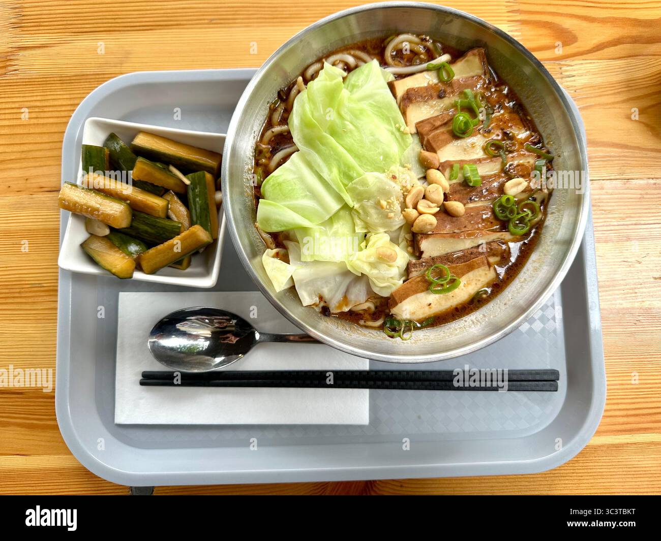 Chongqing noodles with smoked tofu and cucumber salad at a restaurant in Berlin - Smartphone Captured Stock Image