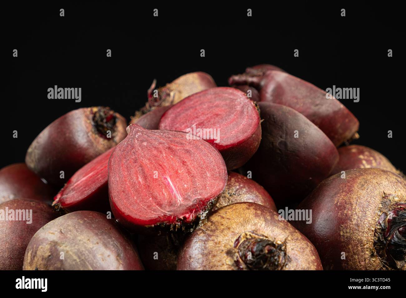 Fresh raw red beets beetroot, whole and halved. Stock Photo