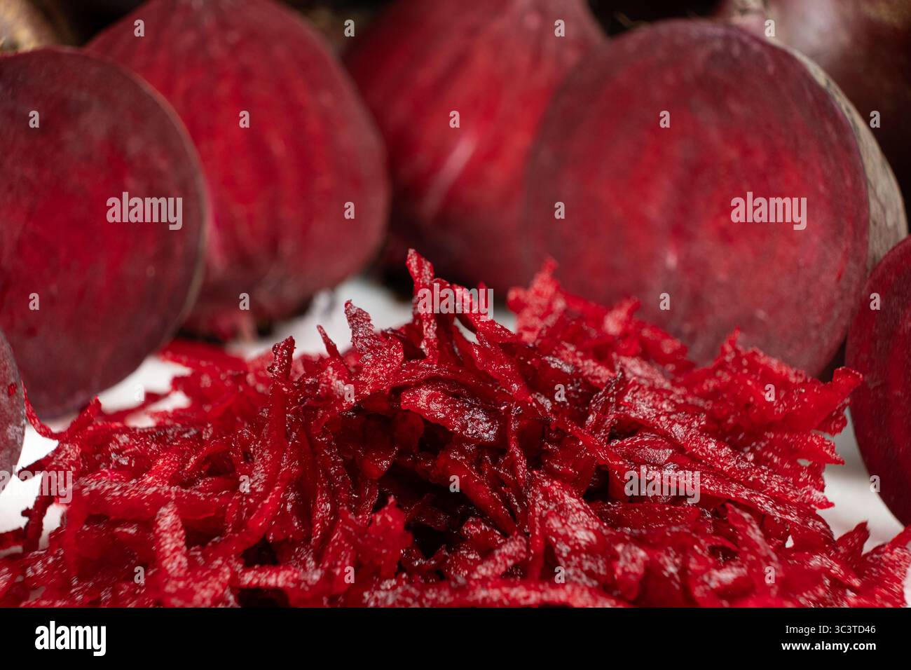 Fresh raw red beetroot grated, beet recipes. Stock Photo