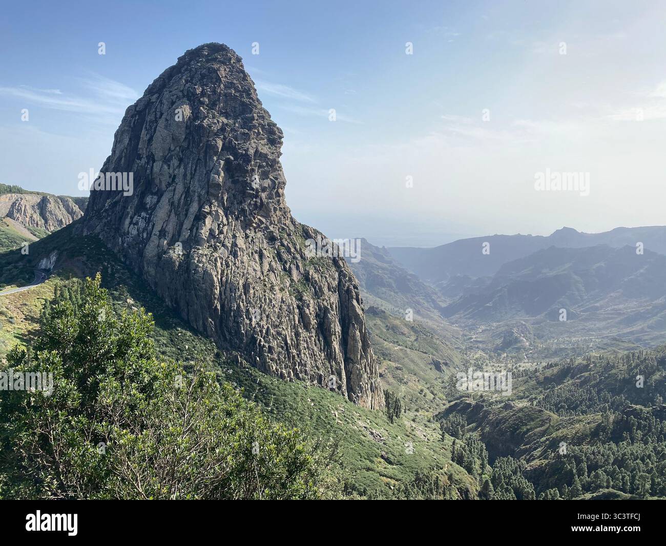 Roque de Agando rock formation against a clear blue sky, showcasing a beautiful landscape of Garajonay National Park, La Gomera, Canary Islands - Smartphone Captured Stock Image