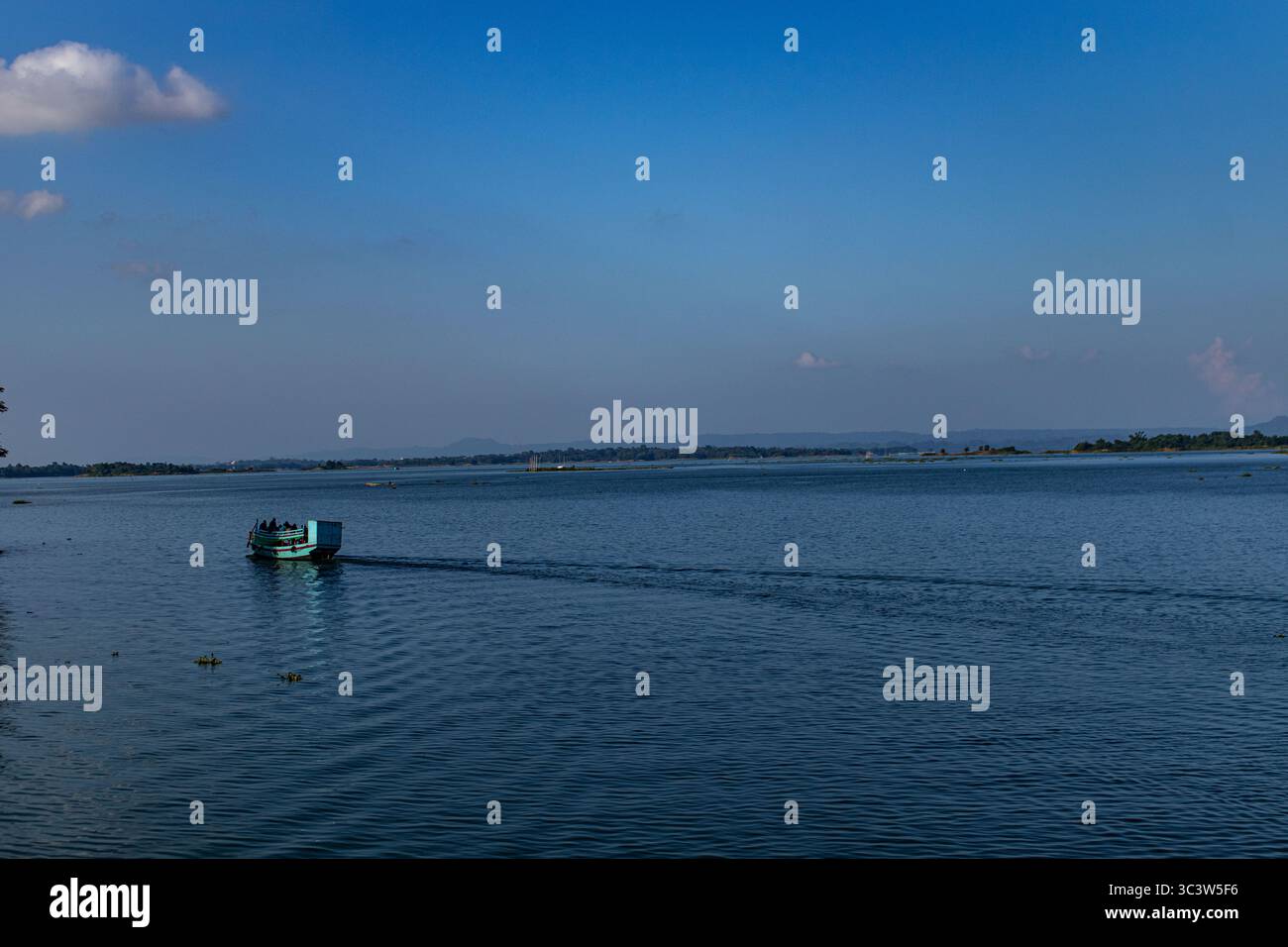 Blue lake with floating boats and cloudy sky in Rangamati. Stock Photo