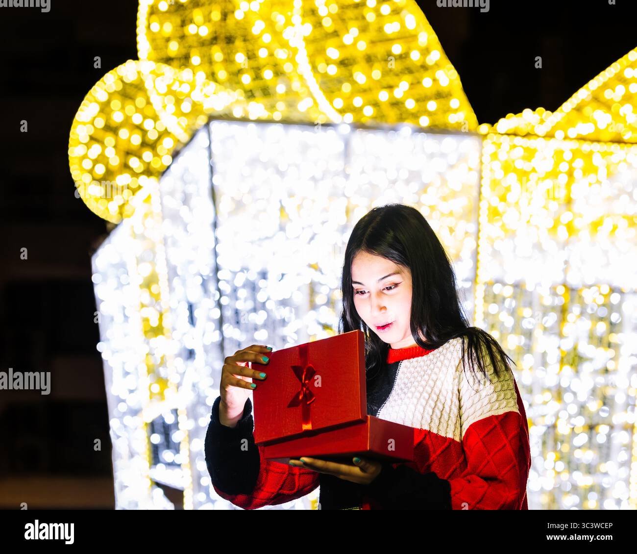 Woman opens festive red hi-res stock photography and images - Alamy