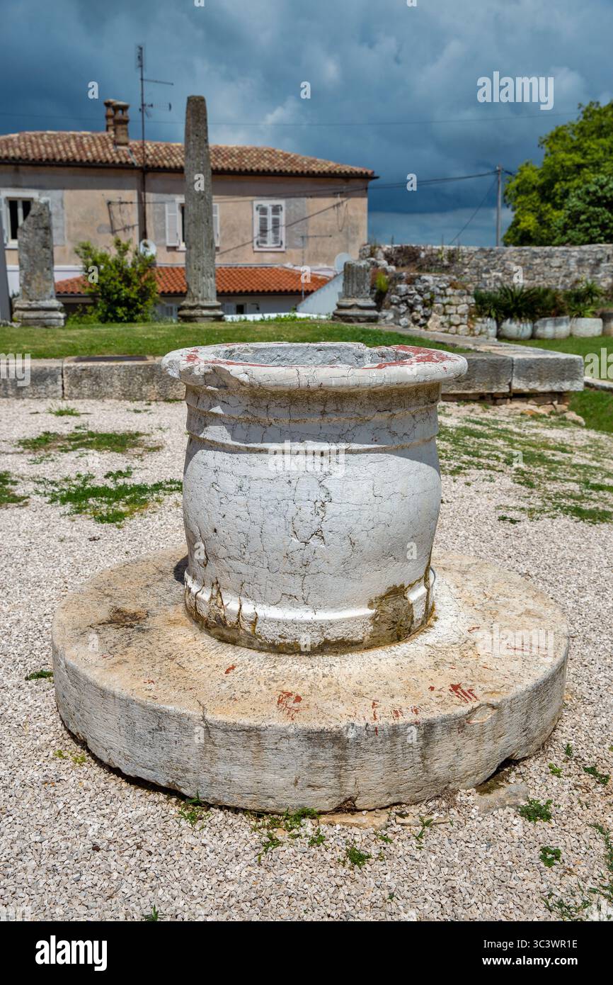 Ancient Rome Well Ancient weathered stone well with Roman columns and ruins in ...