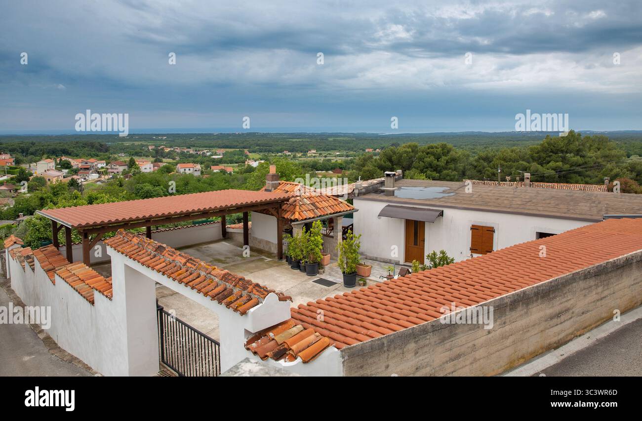 Traditional Croatian house rooftops with red clay tiles, terraces, and ...