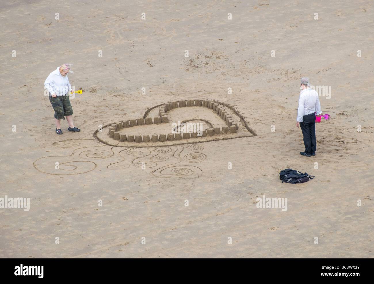 Whitby, North Yorkshire, England. UK. 27th July, 2025. Bright and breezy with a cool brisk wind on Whitby beach on the Yorkshire coast. Credit: Alan Dawson/Alamy Live News Stock Photo