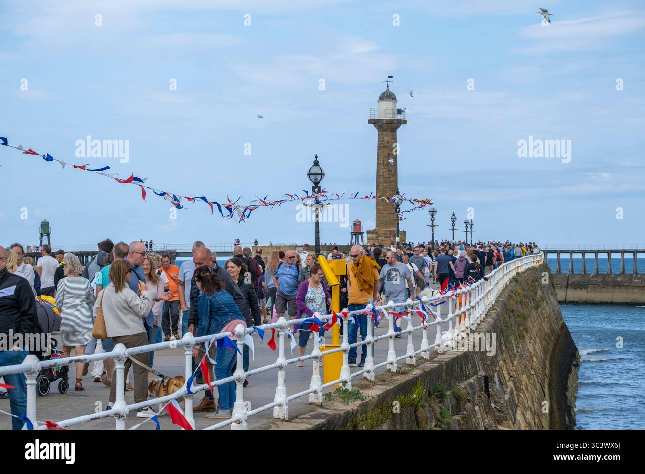 Whitby, North Yorkshire, England. UK. 27th July, 2025. Bright and breezy with a cool brisk wind on Whitby beach on the Yorkshire coast. Credit: Alan Dawson/Alamy Live News Stock Photo