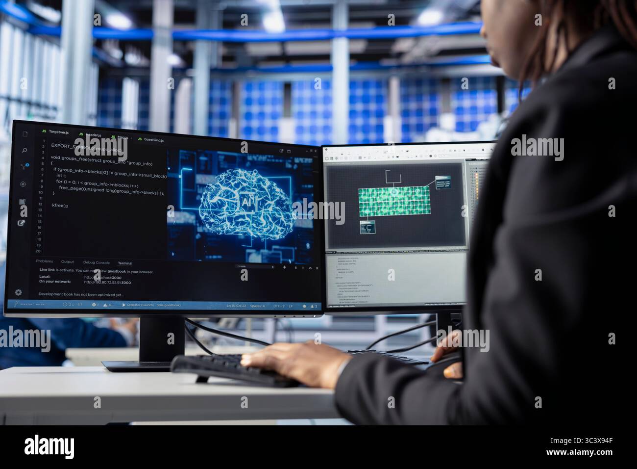 Technician building artificial intelligence solutions in solar panel factory, applying machine learning algorithms to predict errors and automatically adjust production processes Stock Photo