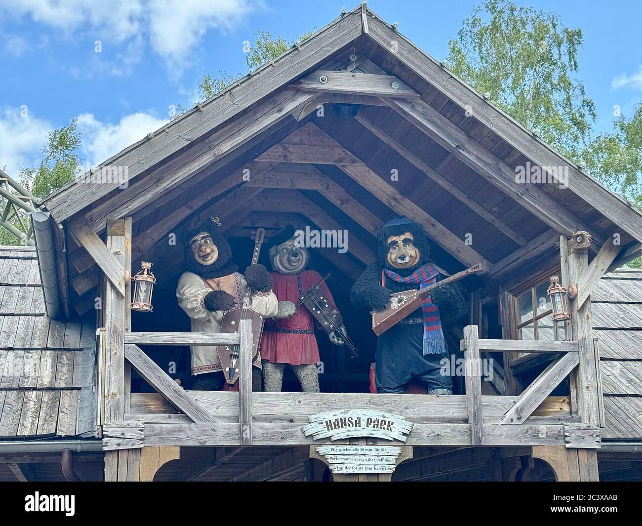Animatronic bear band performing on a wooden balcony at Hansa Park amusement park in Germany. - Smartphone Captured Stock Image