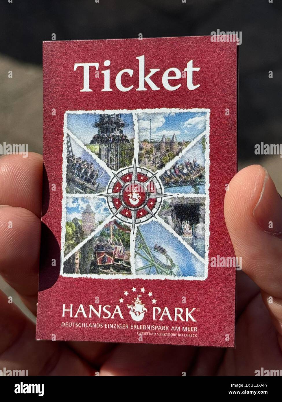 Close-up of a hand holding a Hansa Park admission ticket, Germany’s only amusement park by the sea, located near Lübeck. - Smartphone Captured Stock Image