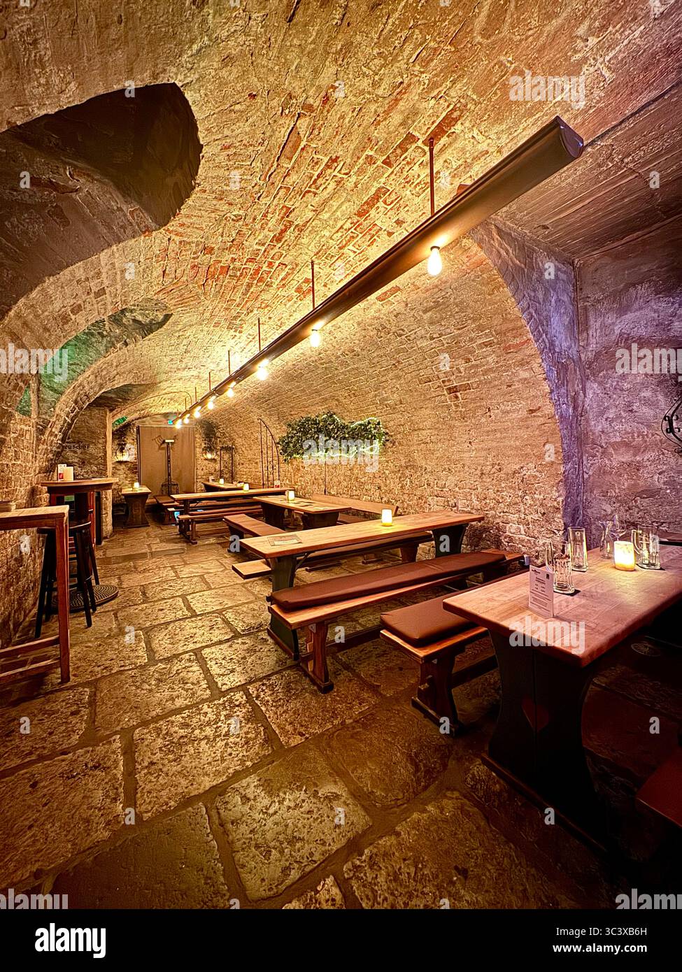 Traditional brewery cellar interior at Brauberger in Lübeck, Germany, showcasing historic brewing equipment, medieval decor, and cultural heritage. - Smartphone Captured Stock Image