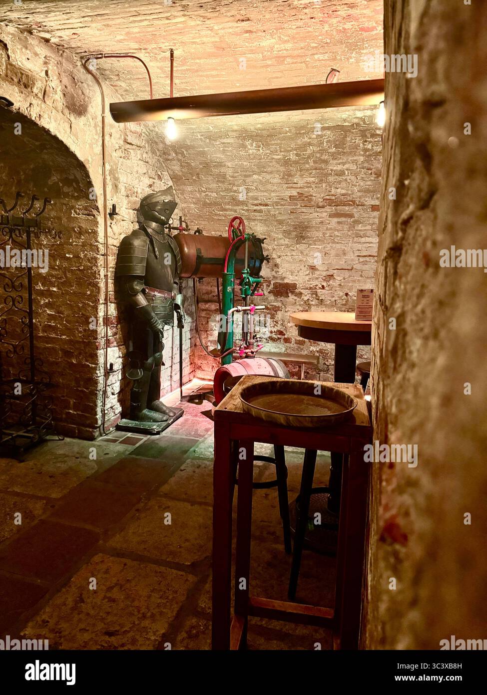 Traditional brewery cellar interior at Brauberger in Lübeck, Germany, showcasing historic brewing equipment, medieval decor, and cultural heritage. - Smartphone Captured Stock Image