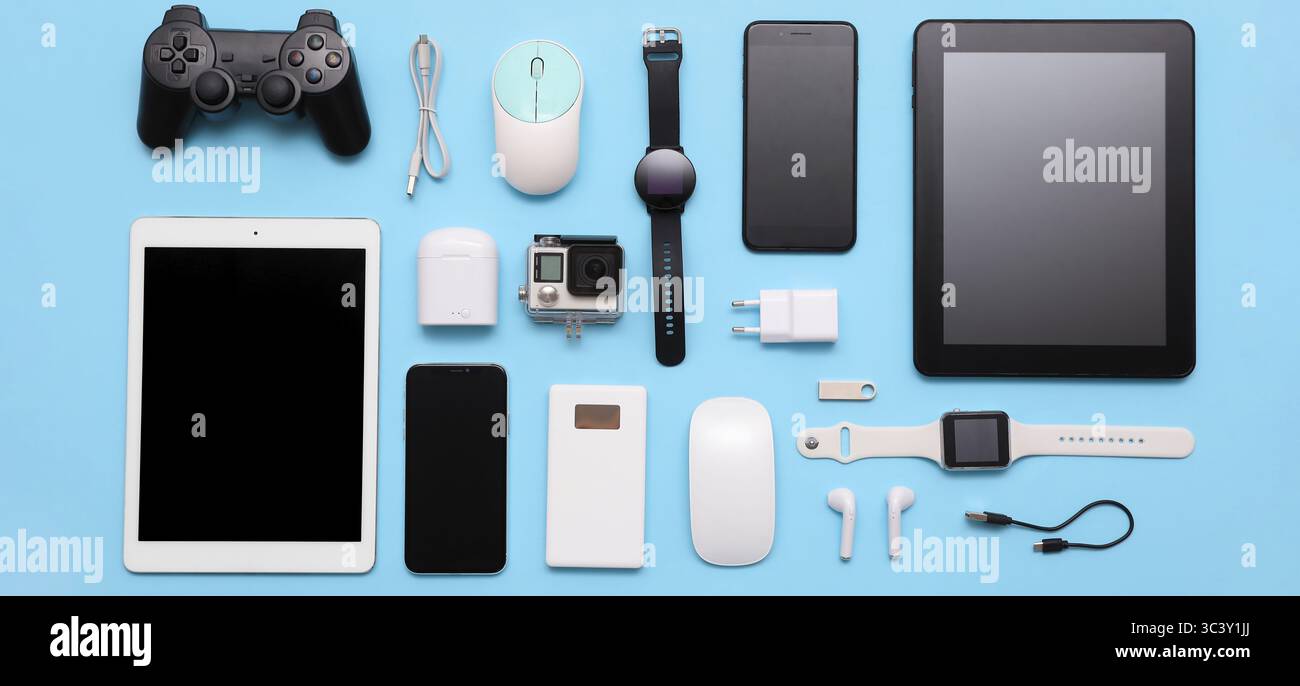 Many different modern gadgets on light blue background Stock Photo