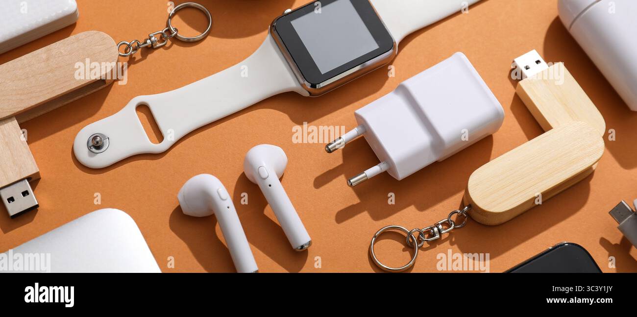 Many different modern gadgets on orange background Stock Photo