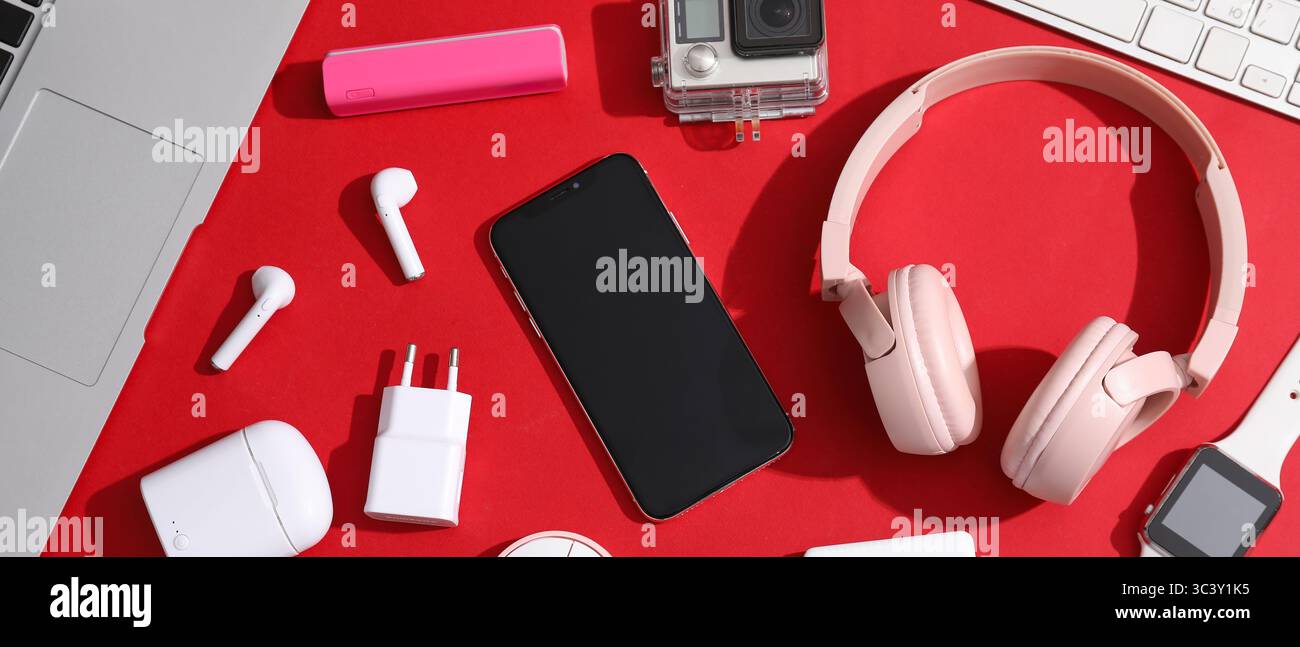 Many different modern gadgets on red background Stock Photo