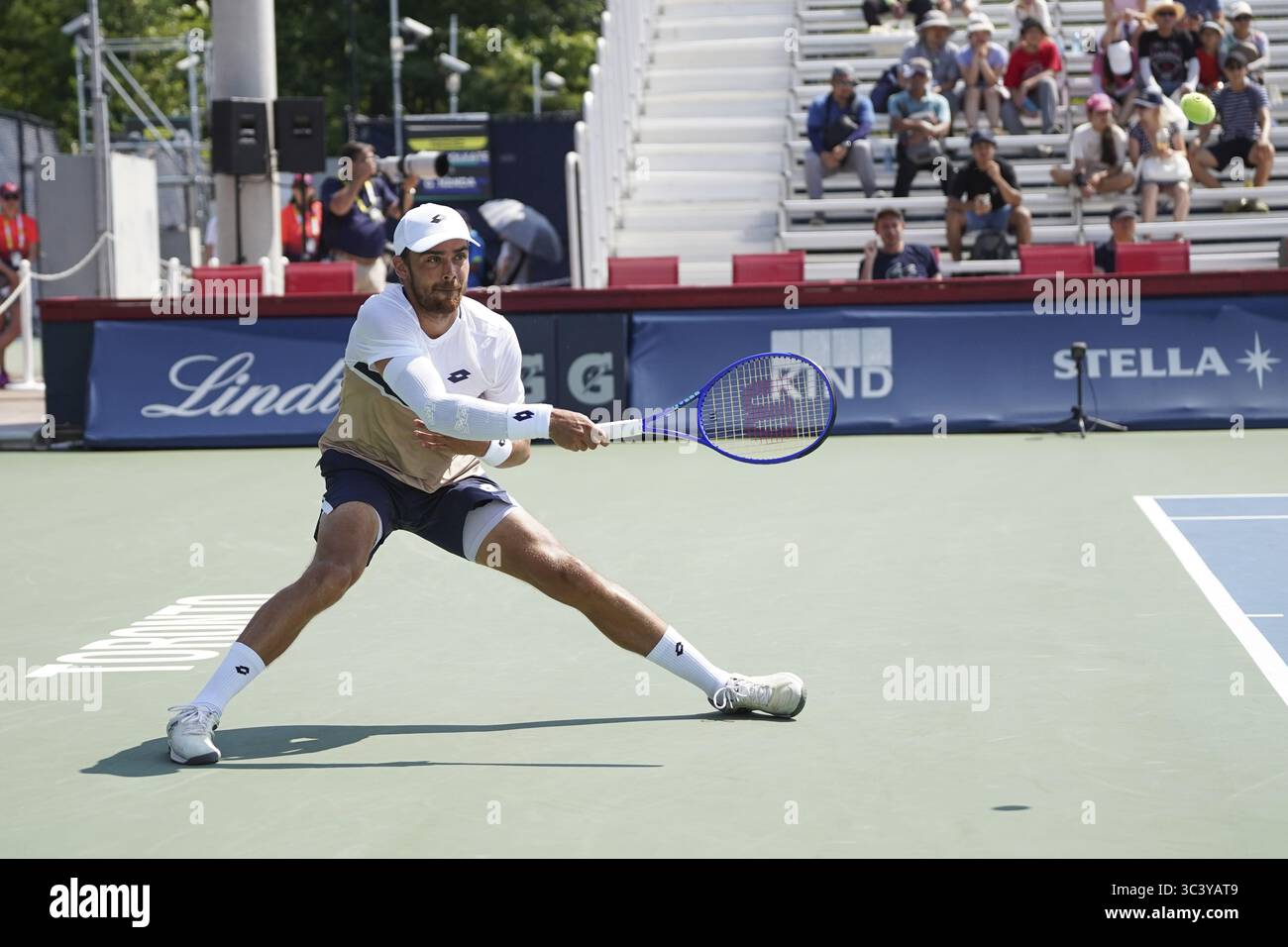 Non Exclusive: Benjamin Bonzi of France lunges to play a forehand against Adam Walton of the United States during the Men's Singles first round match Stock Photo