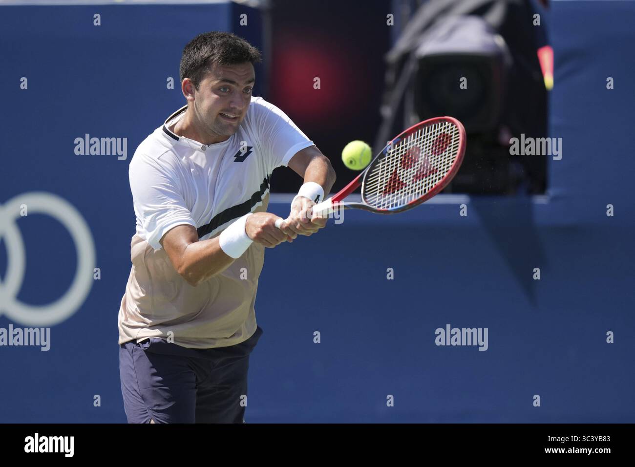 Non Exclusive: Tomas Barrios Vera of Chile plays a backhand against Gael Monfils of France during the Men's Singles first round match on day 2 of the Stock Photo