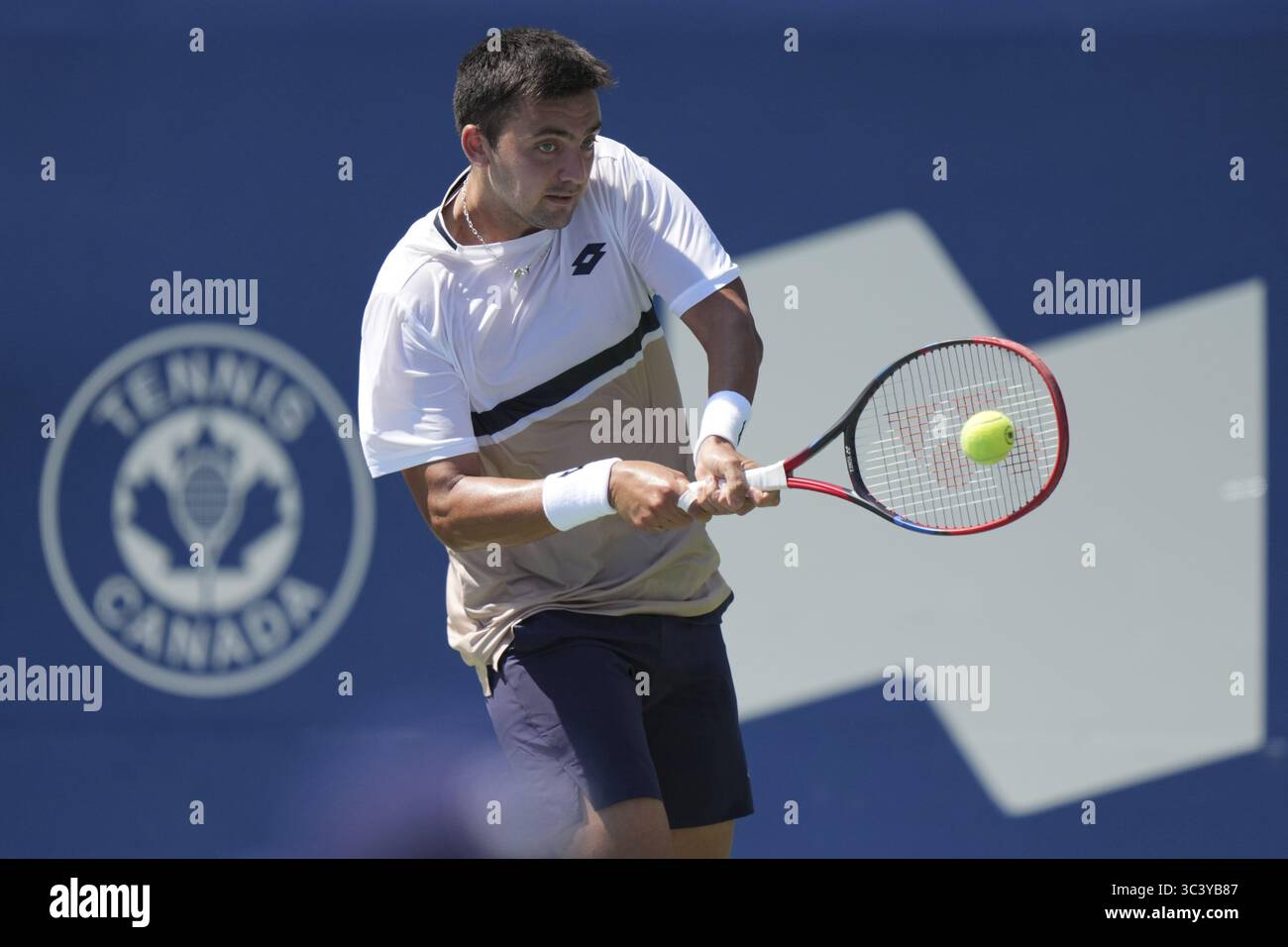 Non Exclusive: Tomas Barrios Vera of Chile plays a backhand against Gael Monfils of France during the Men's Singles first round match on day 2 of the Stock Photo