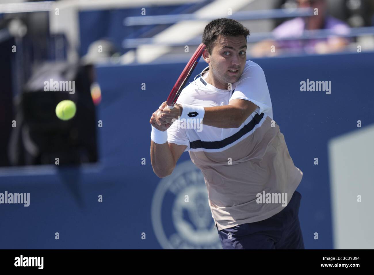 Non Exclusive: Tomas Barrios Vera of Chile plays a backhand against Gael Monfils of France during the Men's Singles first round match on day 2 of the Stock Photo