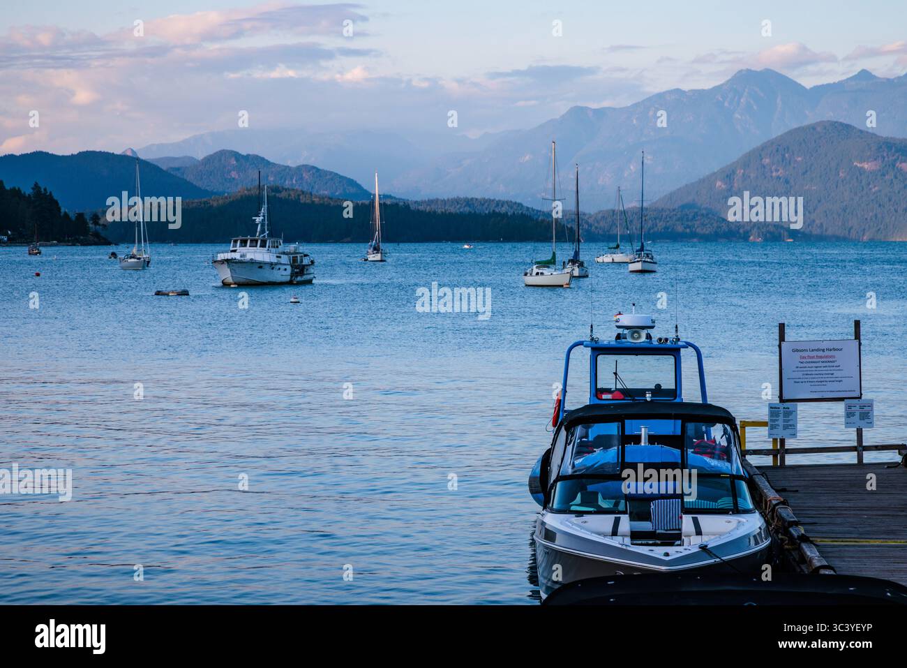 Boats anchored in the harbour at dusk in Gibsons on the west coast of Canada. Stock Photo