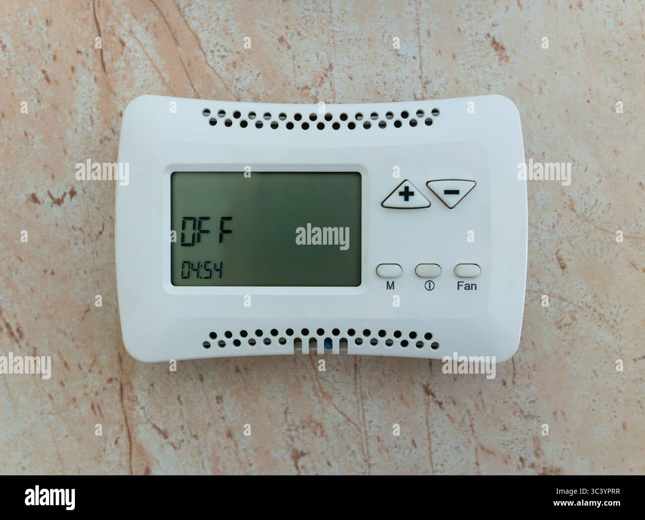 Climate control system control panel mounted on the wall in the off state. Stock Photo
