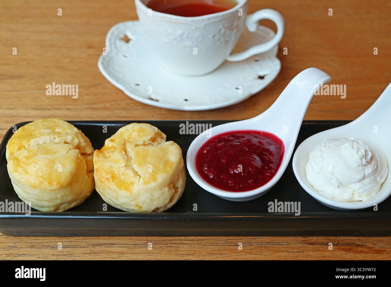 Closeup of Delectable Scones with a Teacup in the Backdrop Stock Photo