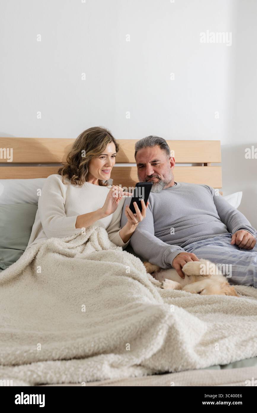 Man reclining on bed tapping hi-res stock photography and images - Alamy