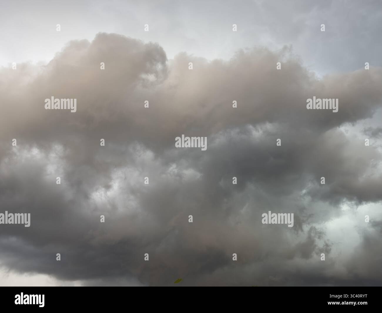 Dark discoloured storm clouds Cloud roll above grey clouds Rain clouds herald thunderstorms, Germany Stock Photo