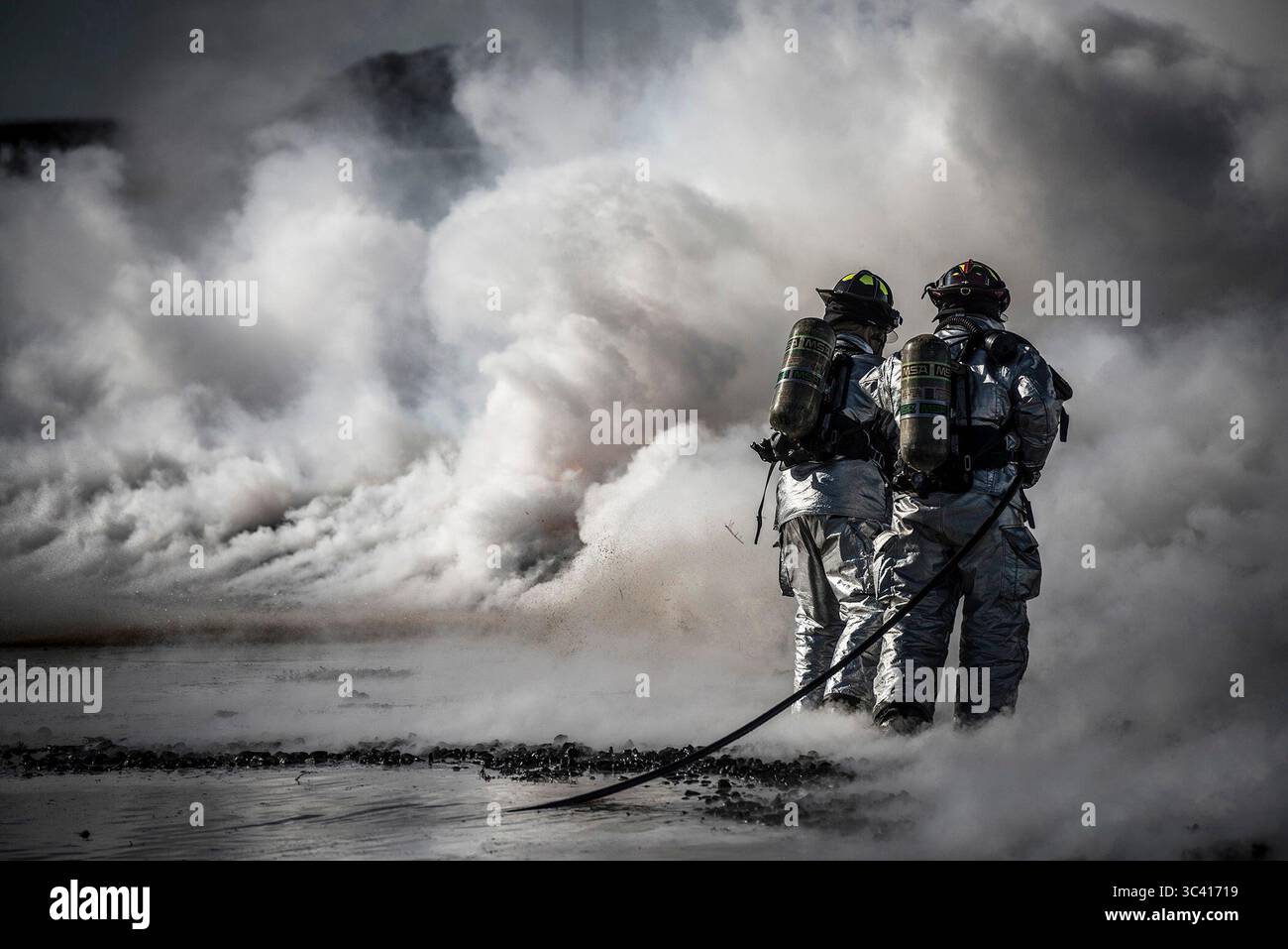 U.S. Air Force firefighters extinguish a fire during a fire training ...