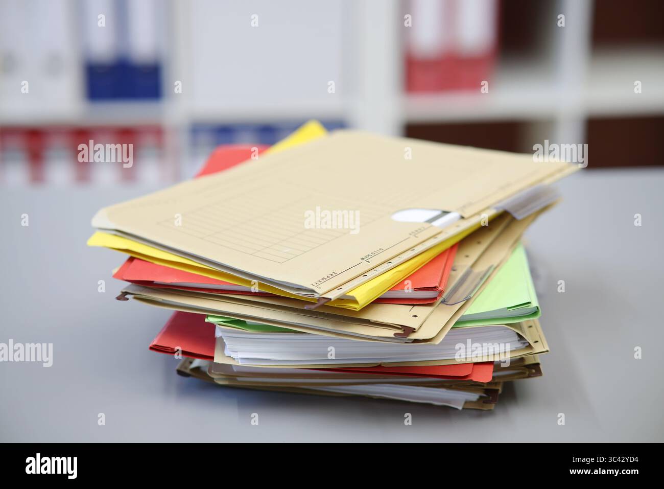 Different colored files lying on a desk, brown Stock Photo
