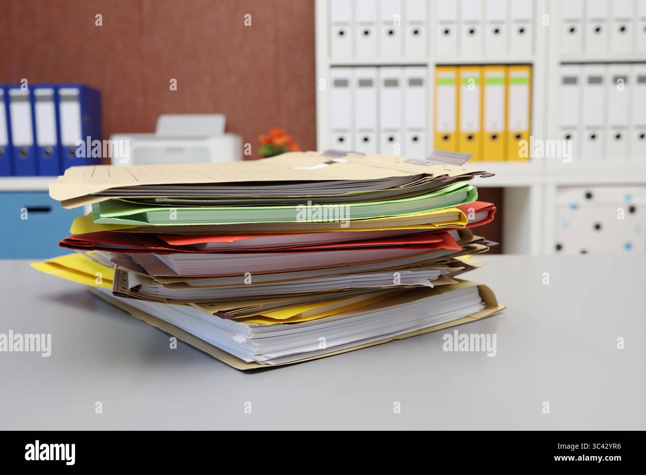 Different colored files lying on a desk, side view Stock Photo