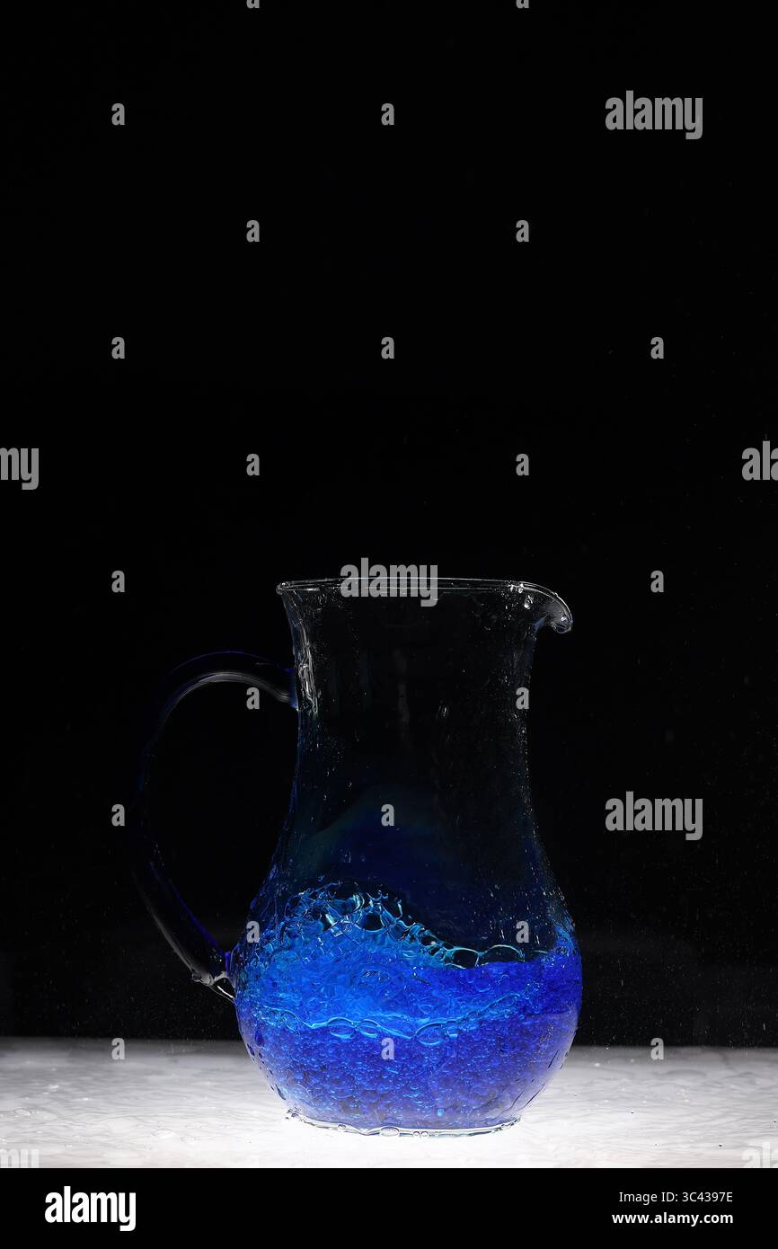 Water explosion in water vessel, blue Stock Photo