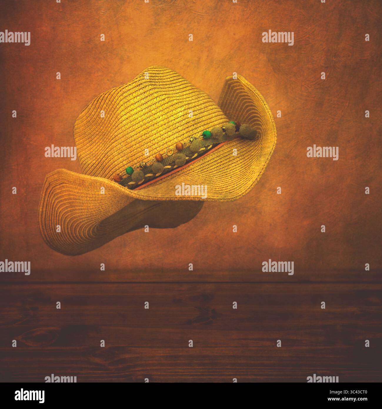 New ladies straw cowboy hat floating above a wooden table with a textured distressed background. UK, 2025 - Stock Image