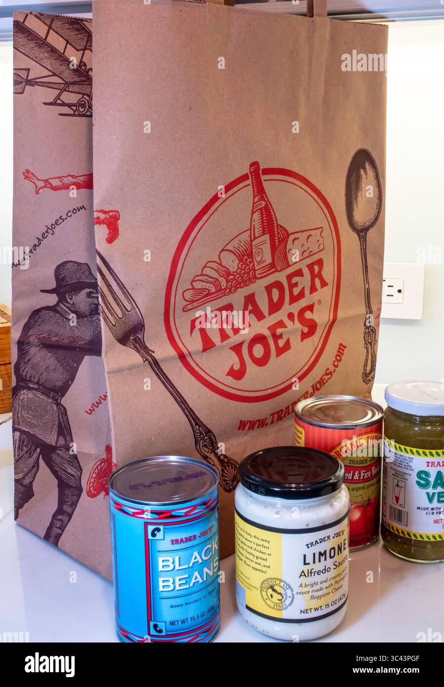 Kitchen counter with store brand products and Trader Joe's shopping bag,  USA  2025 Stock Photo