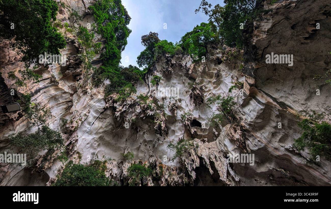 breathtaking sunset photography scene unfolds at Batu Caves Malaysia, where a golden hour sky meets urban tower lights and road night lighting. From - Smartphone Captured Stock Image