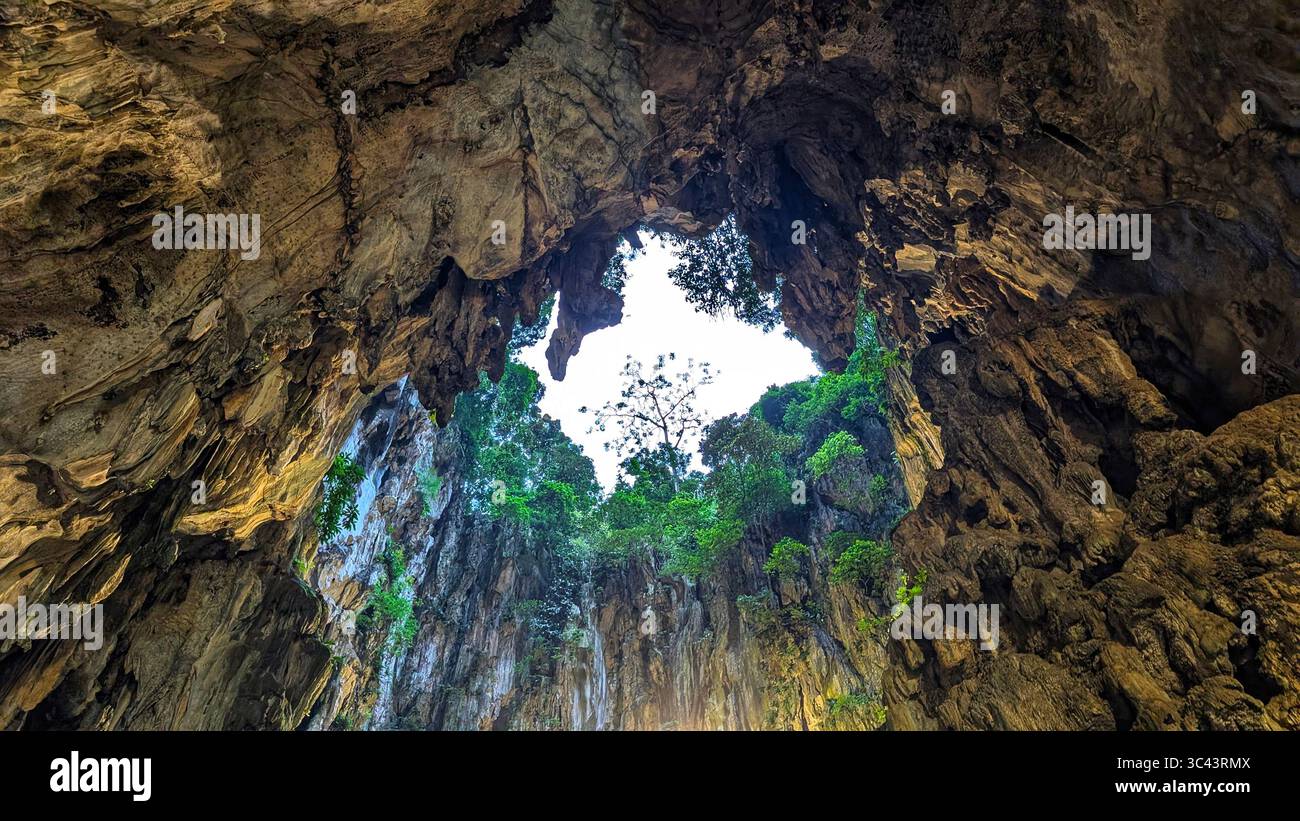 breathtaking sunset photography scene unfolds at Batu Caves Malaysia, where a golden hour sky meets urban tower lights and road night lighting. From - Smartphone Captured Stock Image