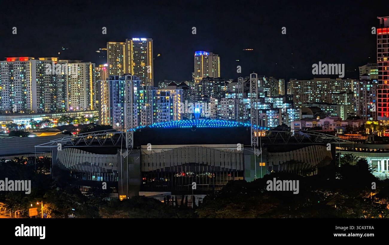 breathtaking sunset photography scene unfolds at Batu Caves Malaysia, where a golden hour sky meets urban tower lights and road night lighting. From - Smartphone Captured Stock Image
