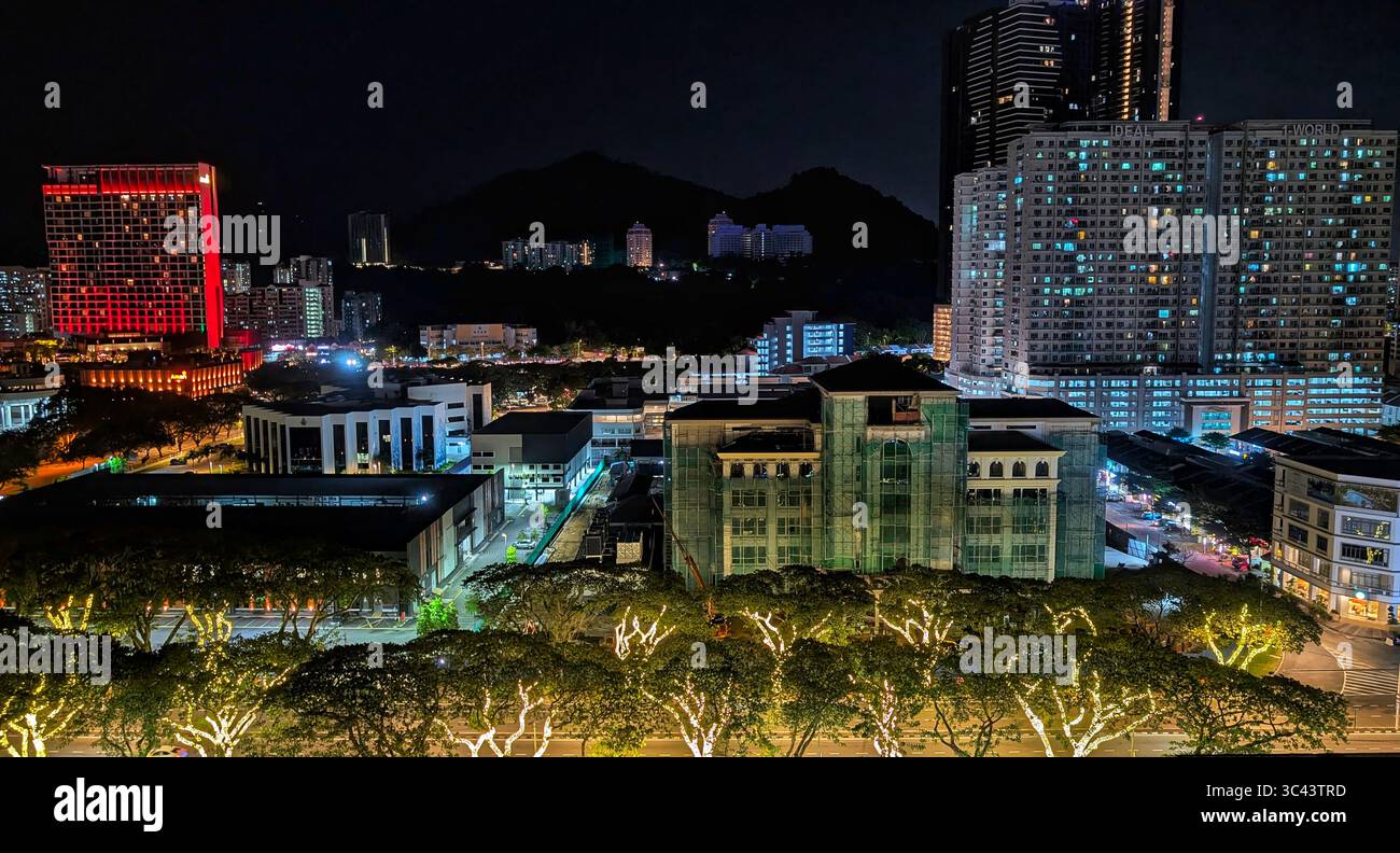 breathtaking sunset photography scene unfolds at Batu Caves Malaysia, where a golden hour sky meets urban tower lights and road night lighting. From - Smartphone Captured Stock Image