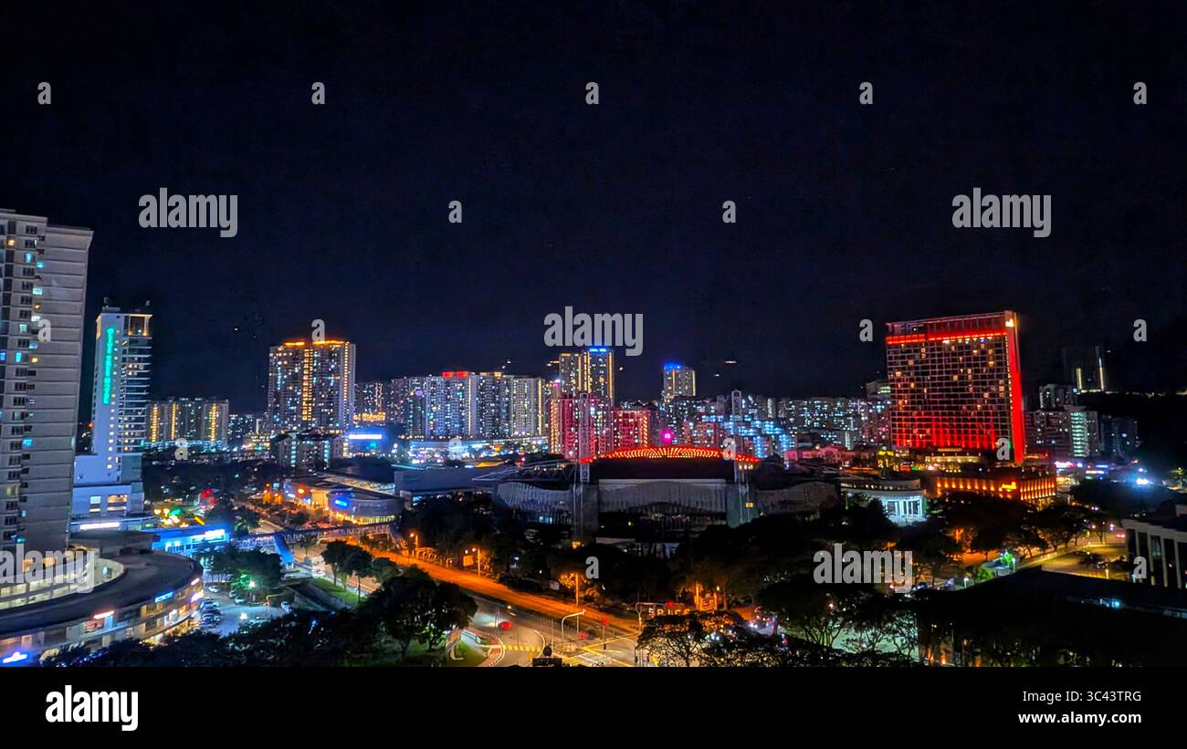 breathtaking sunset photography scene unfolds at Batu Caves Malaysia, where a golden hour sky meets urban tower lights and road night lighting. From - Smartphone Captured Stock Image