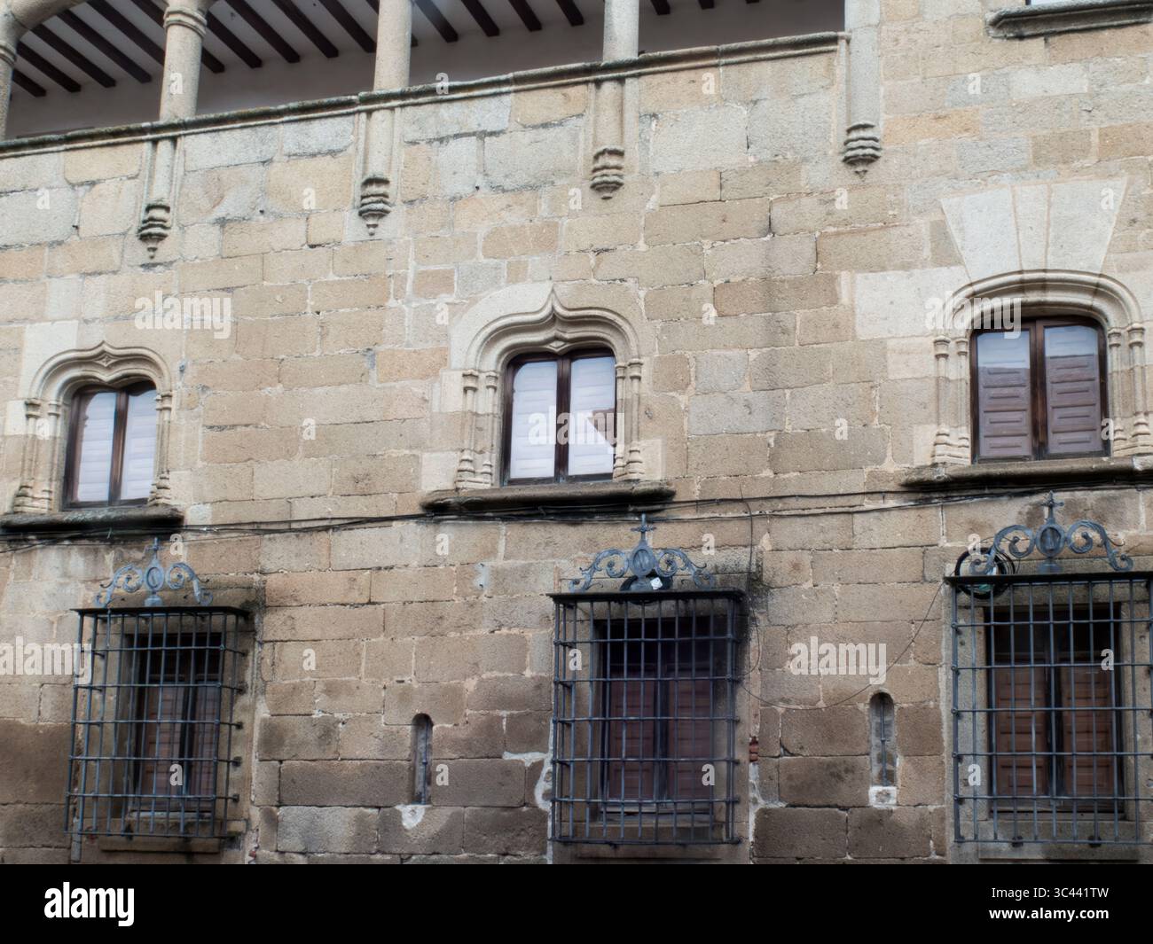 Stone facade of a historical building showcasing ornate windows and ...
