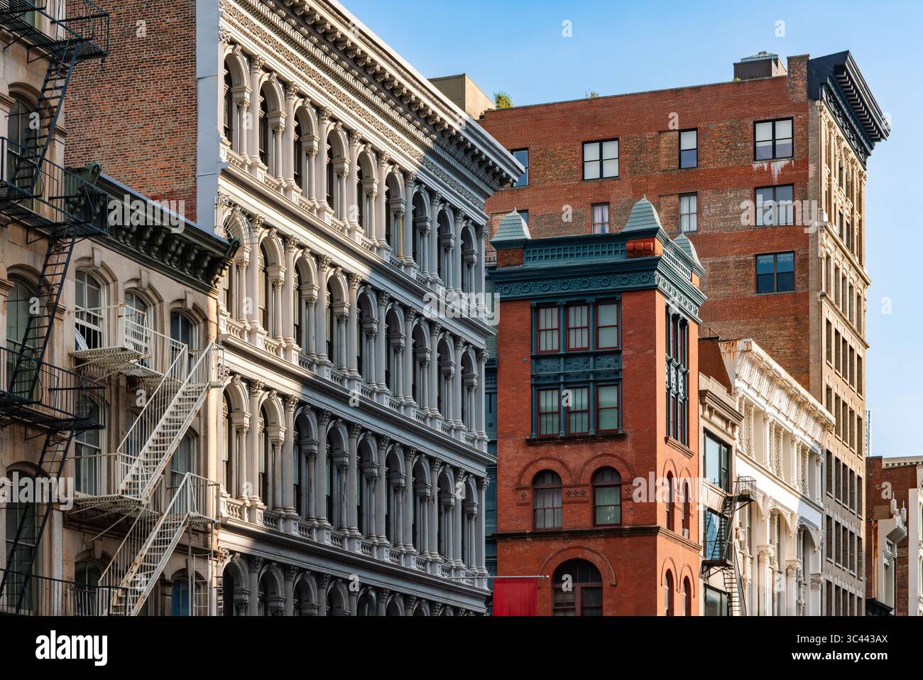 Historic buildings with ornate facades and fire escapes in SoHo Cast Iron Historic District, Manhattan. Broadway, New York City Stock Photo